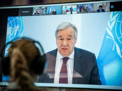 United Nations Secretary-General Antonio Guterres is seen on a screen during the video conference of the Petersberg Climate Dialogue in Berlin on April 28, 2020.