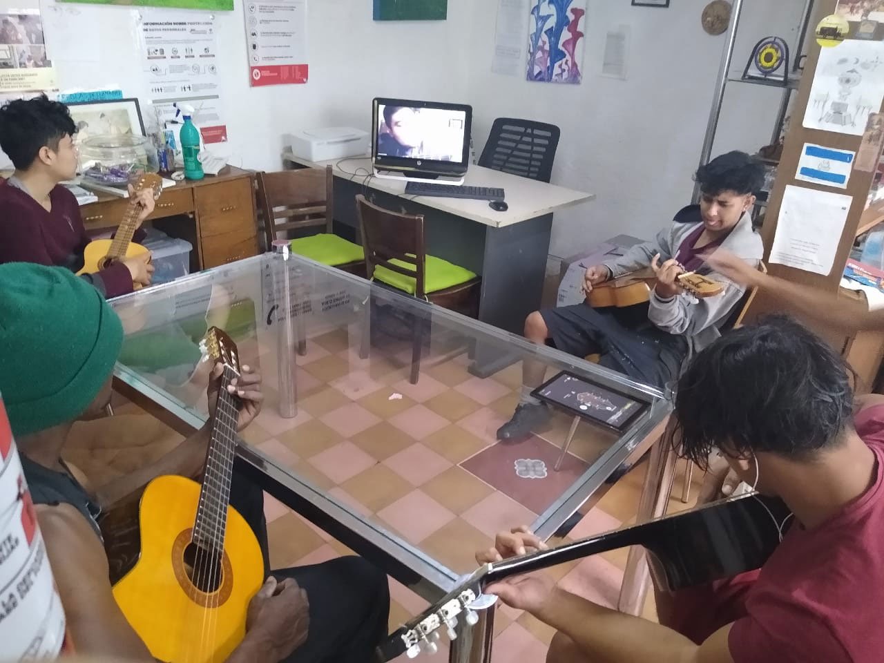 To pass the time, migrants in Casa Tochan in Mexico City receive a guitar class, given by a volunteer over Zoom.