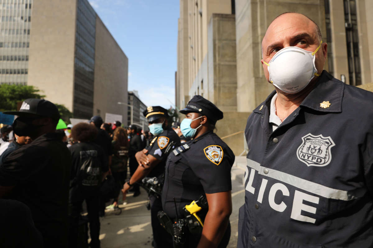 Police watch as protesters gather in front of a Manhattan court house and jail to protest the death of George Floyd on May 29, 2020, in New York City.