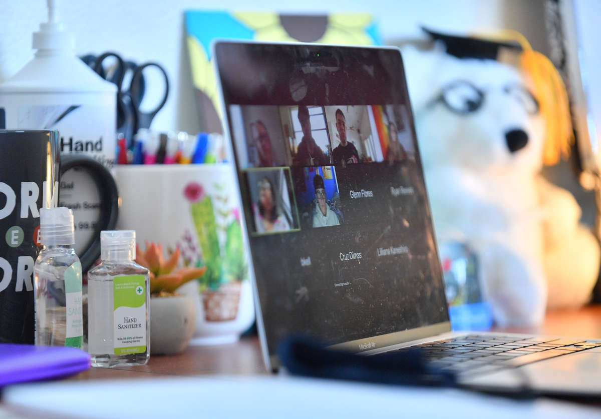 Bottles of hand sanitizer sit next to a laptop showing a Zoom meeting as students begin classes amid the COVID-19 pandemic on the first day of the fall 2020 semester at the University of New Mexico on August 17, 2020, in Albuquerque, New Mexico.