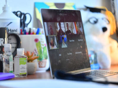Bottles of hand sanitizer sit next to a laptop showing a Zoom meeting as students begin classes amid the COVID-19 pandemic on the first day of the fall 2020 semester at the University of New Mexico on August 17, 2020, in Albuquerque, New Mexico.