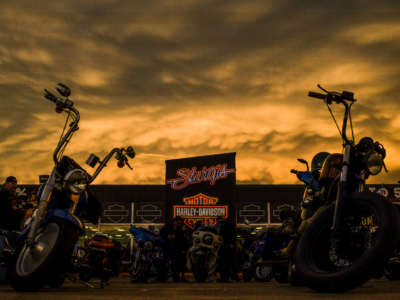 The sunset lights up storm clouds over the Sturgis Harley-Davidson dealership during the 80th Annual Sturgis Motorcycle Rally in Sturgis, South Dakota, on August 8, 2020.