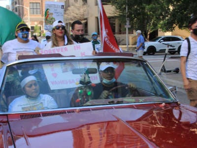 Vanessa Guillén's mother, Gloria Guillén, in the passenger seat of a low-rider during a march to the Texas Capitol building in Austin in support of the family's forthcoming #IamVanessaGuillén bill, on September 7, 2020.