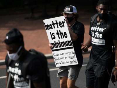 Members of the University of South Carolina football team join student athletes on campus during a demonstration against racial inequality and police brutality on August 31, 2020, in Columbia, South Carolina.