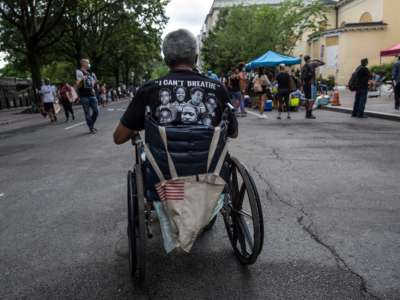 A man in a wheelchair takes part in a demonstration near the White House while protesting against police brutality and racism in Washington D.C., June 13, 2020.