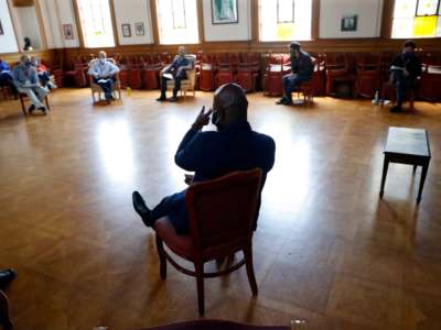 James Dixon, HealthRIGHT 360 Director of Residential Services, leads a staff meeting at the residential drug treatment program in San Francisco, California, on May 20, 2020.