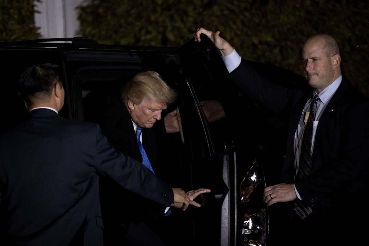 Flanked by U.S. Secret Service agents, then-President-elect Trump gets into his car at Trump International Golf Club, November 20, 2016, in Bedminster Township, New Jersey.