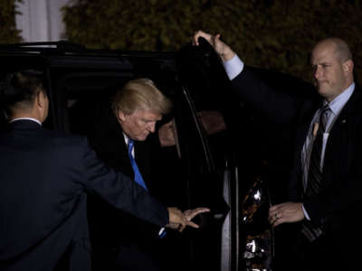 Flanked by U.S. Secret Service agents, then-President-elect Trump gets into his car at Trump International Golf Club, November 20, 2016, in Bedminster Township, New Jersey.