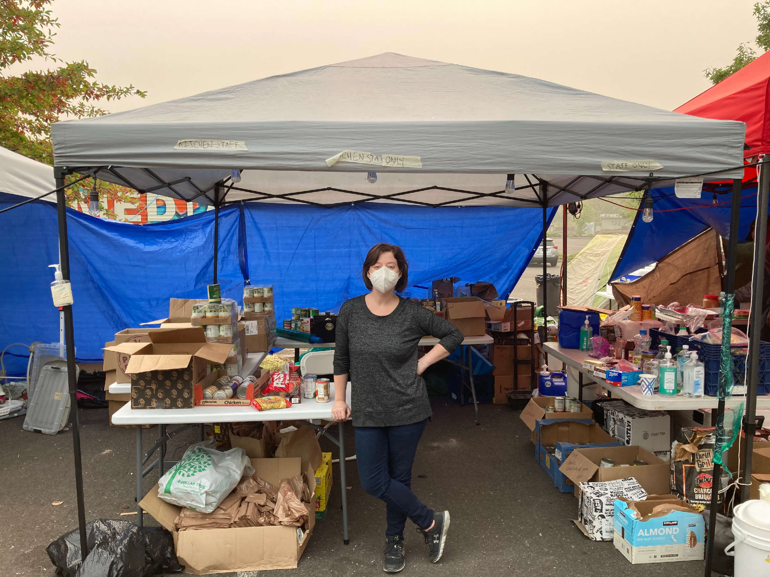 Mutual aid volunteer Melissa Lewis staffs the dry goods tent at the hub.