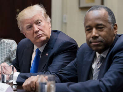 President Trump sits beside the Department of Housing and Urban Development Secretary Ben Carson in the Roosevelt Room of the White House on February 1, 2017, in Washington, D.C.
