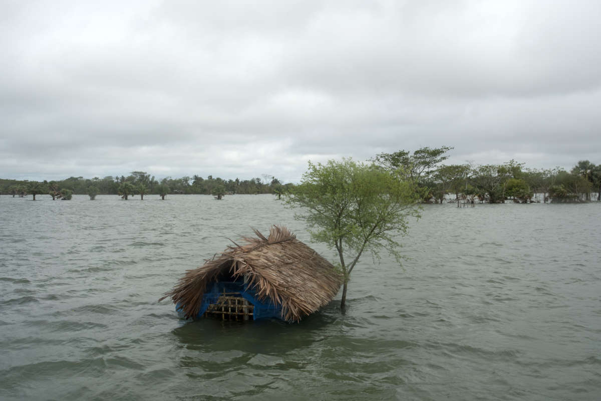 A house sits submerged in floodwaters