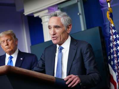 Dr. Scott Atlas speaks while Trump stands behind him