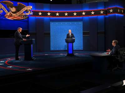 Donald Trump and Joe Biden debate at podiums