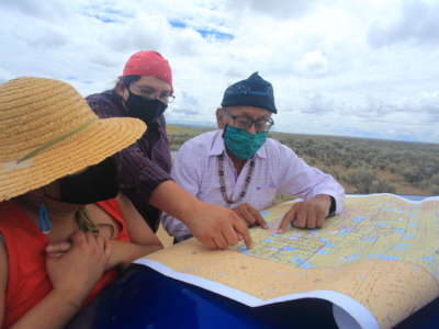Navajo Tribal Council member Daniel Tso (also pictured on the previ- ous page) and Mario Atencio of Diné CARE (middle) study a map of oil leases in the Nation’s Eastern Agency. The BLM’s new guidelines will allow up to 3,000 more frack wells in the Greater Chaco region.