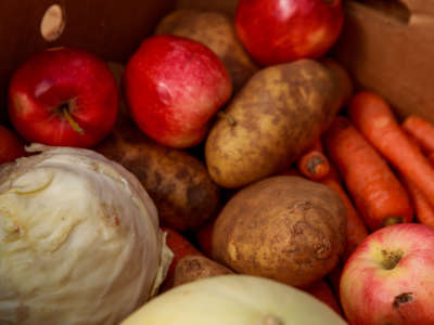 Vegetables are repacked into boxes from the Hoosier Hills Food Bank before arriving at Pantry 279 in Ellettsville, Indiana, to help those experiencing food insecurity during the COVID-19 pandemic.