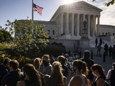 Members of the Georgetown University Women's Rowing Team visit a makeshift memorial in honor of Supreme Court Justice Ruth Bader Ginsburg in front of the Supreme Court on September 19, 2020, in Washington, D.C.