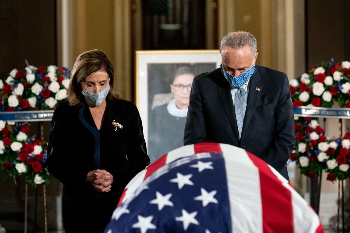 House Speaker Nancy Pelosi and Senate Minority Leader Chuck Schumer pay their respects during a memorial service for Justice Ruth Bader Ginsburg as she lies in state in Statuary Hall of the U.S. Capitol on September 25, 2020, in Washington, D.C.