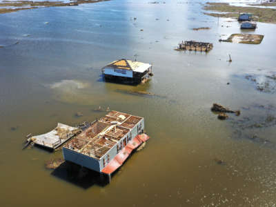 An aerial view from a drone shows a damaged home surrounded by water on August 29, 2020, in Little Chenier, Louisiana.