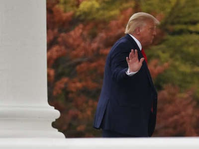 Donald Trump waves to journalists as he returns to the White House following a trip to Wisconsin on September 1, 2020, in Washington, D.C.