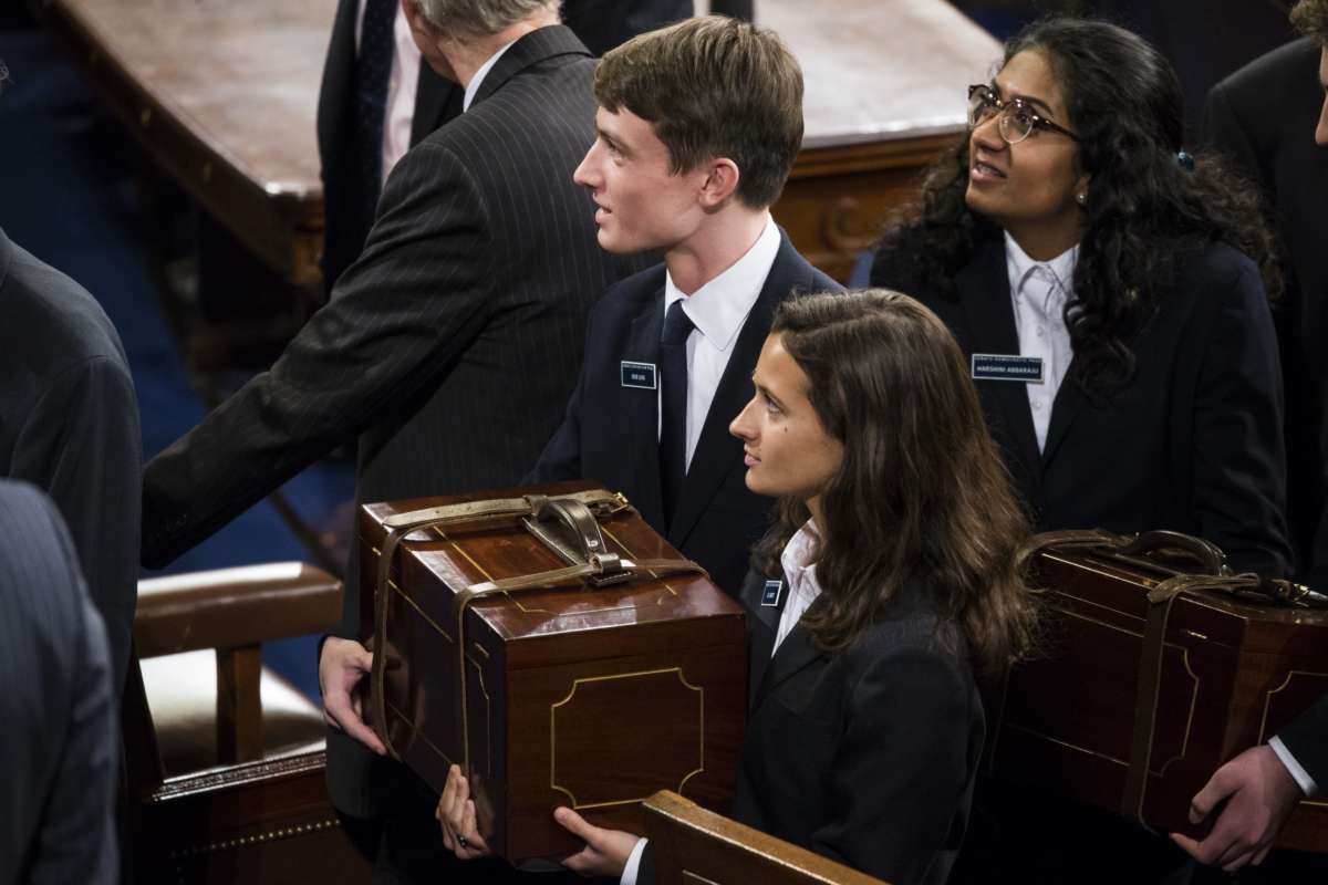 Congressional pages carry the chests containing the Electoral College votes from the states and territories for president of the United States during a joint session of Congress at the U.S. Capitol in Washington on January 6, 2017.