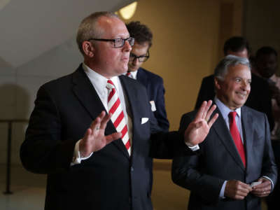 Former Trump campaign aide Michael Caputo (left) waves goodbye to reporters after he testified before the House Intelligence Committee during a closed-door session at the U.S. Capitol Visitors Center on July 14, 2017, in Washington, D.C.