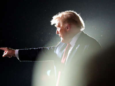 President Trump waves goodbye to supporters as he departs his campaign rally at Orlando Sanford International Airport on October 12, 2020, in Sanford, Florida.