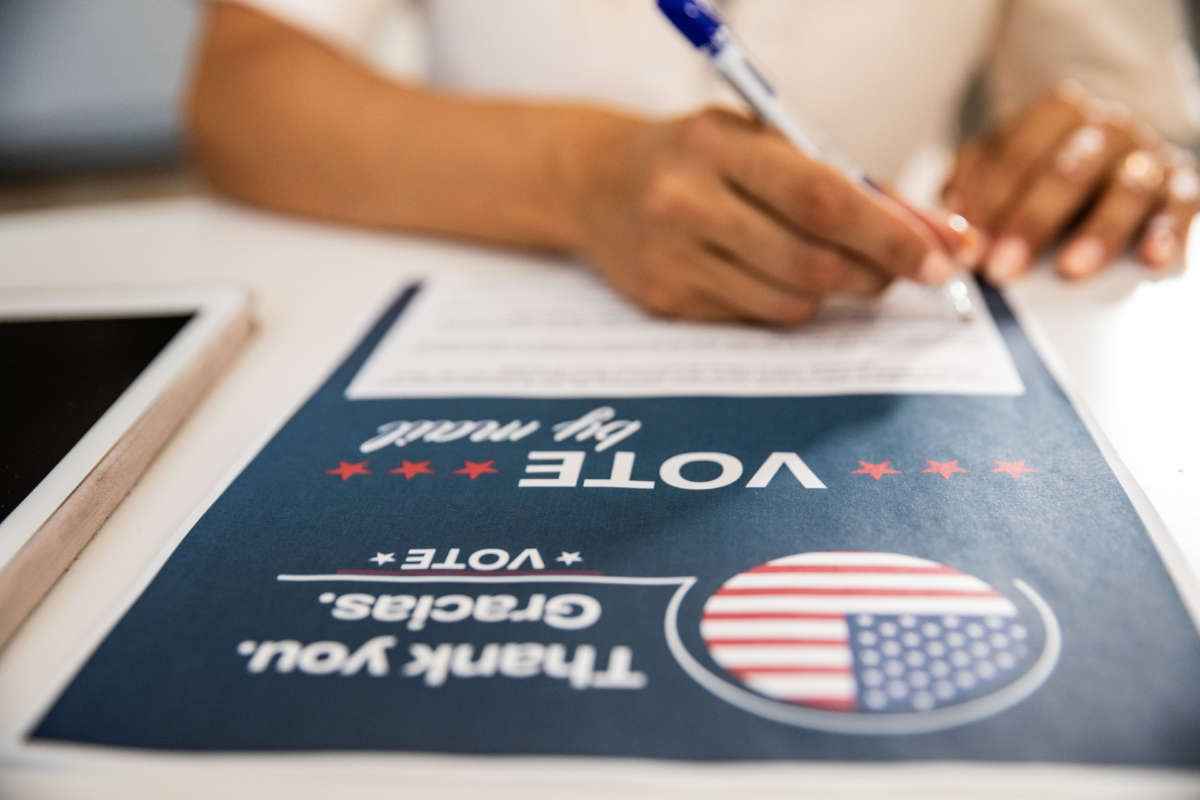 A person fills out a vote-by-mail application