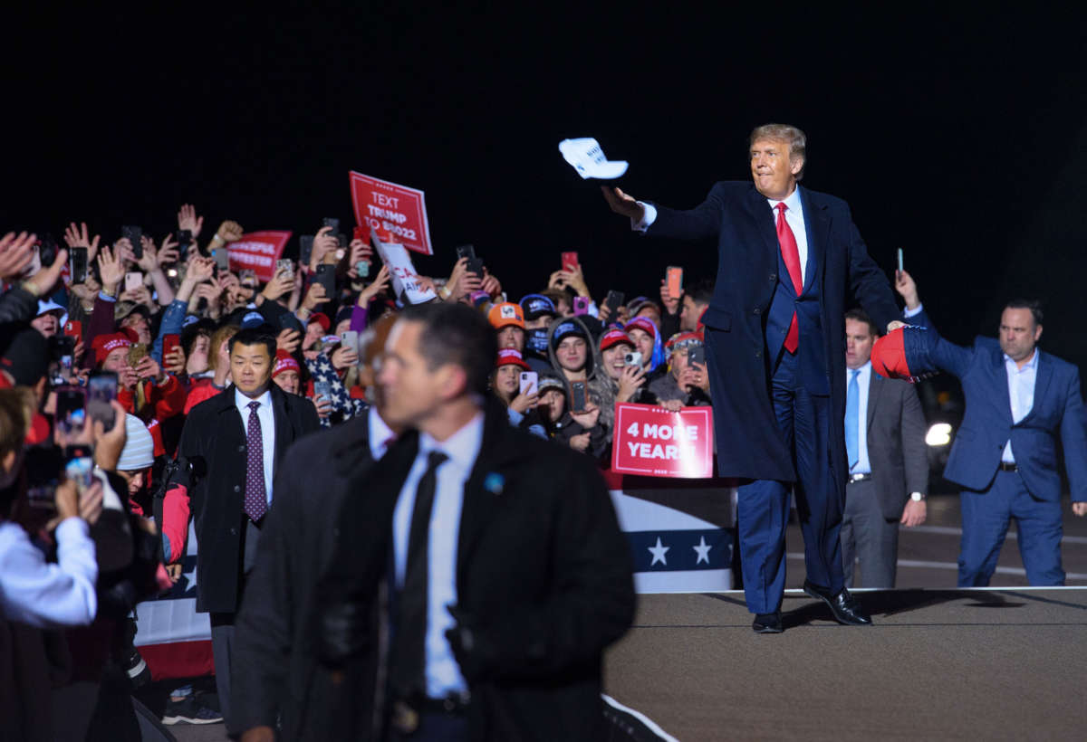 President Trump tosses a cap to supporters as he arrives for a campaign rally at Duluth International Airport in Duluth, Minnesota, on September 30, 2020.