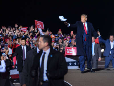 President Trump tosses a cap to supporters as he arrives for a campaign rally at Duluth International Airport in Duluth, Minnesota, on September 30, 2020.