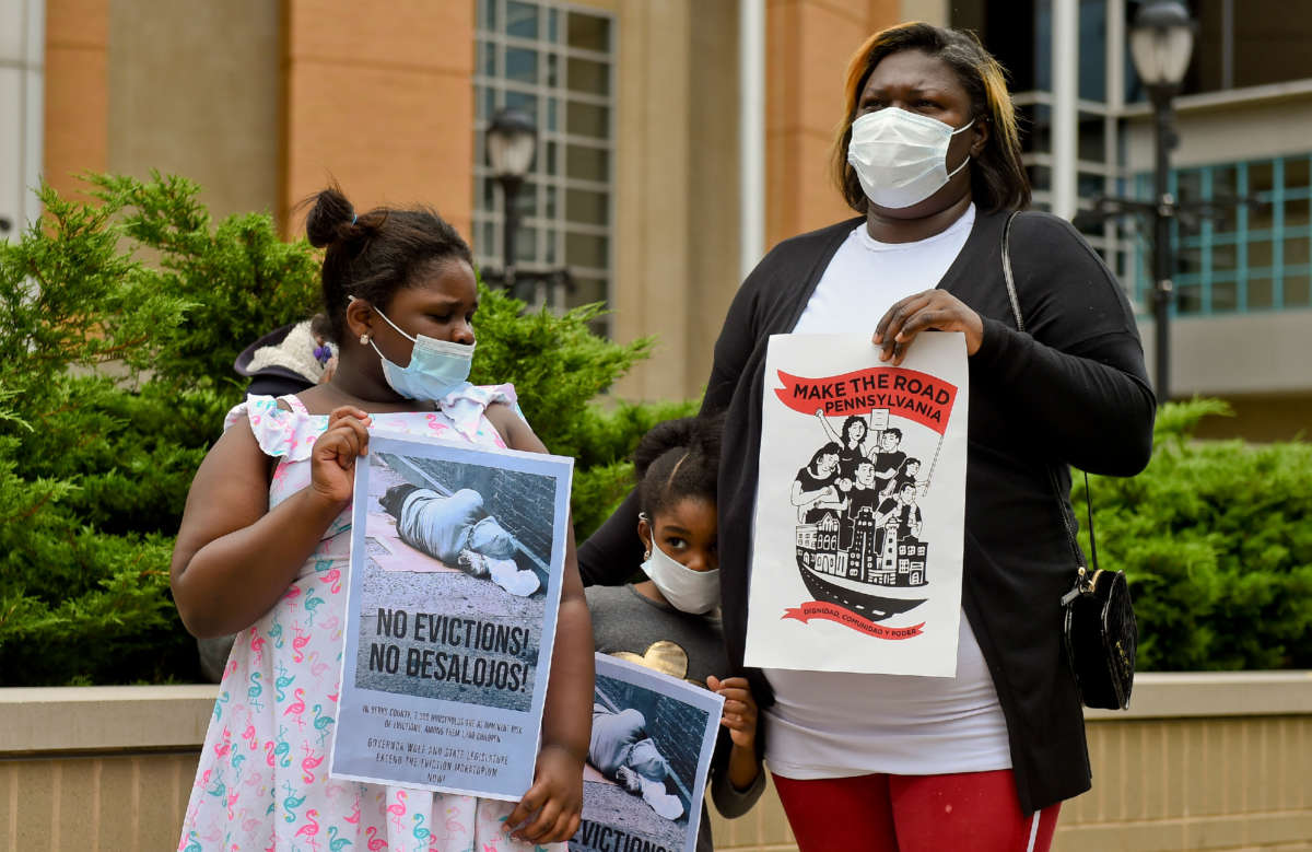 Migreldi Lara, a single mother of three who is out of work as a hair stylist due to the pandemic, stands with her daughters during a protest outside the Berks County Services Building in Reading, Pennsylvania, on September 1, 2020.