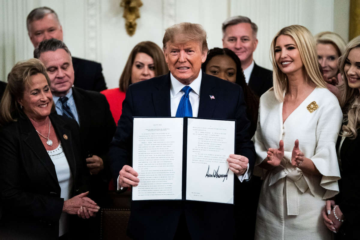 President Trump, with Ivanka Trump, signs an executive order after delivering remarks at the White House Summit on Human Trafficking in the East Room at the White House on January 31, 2020, in Washington, D.C.