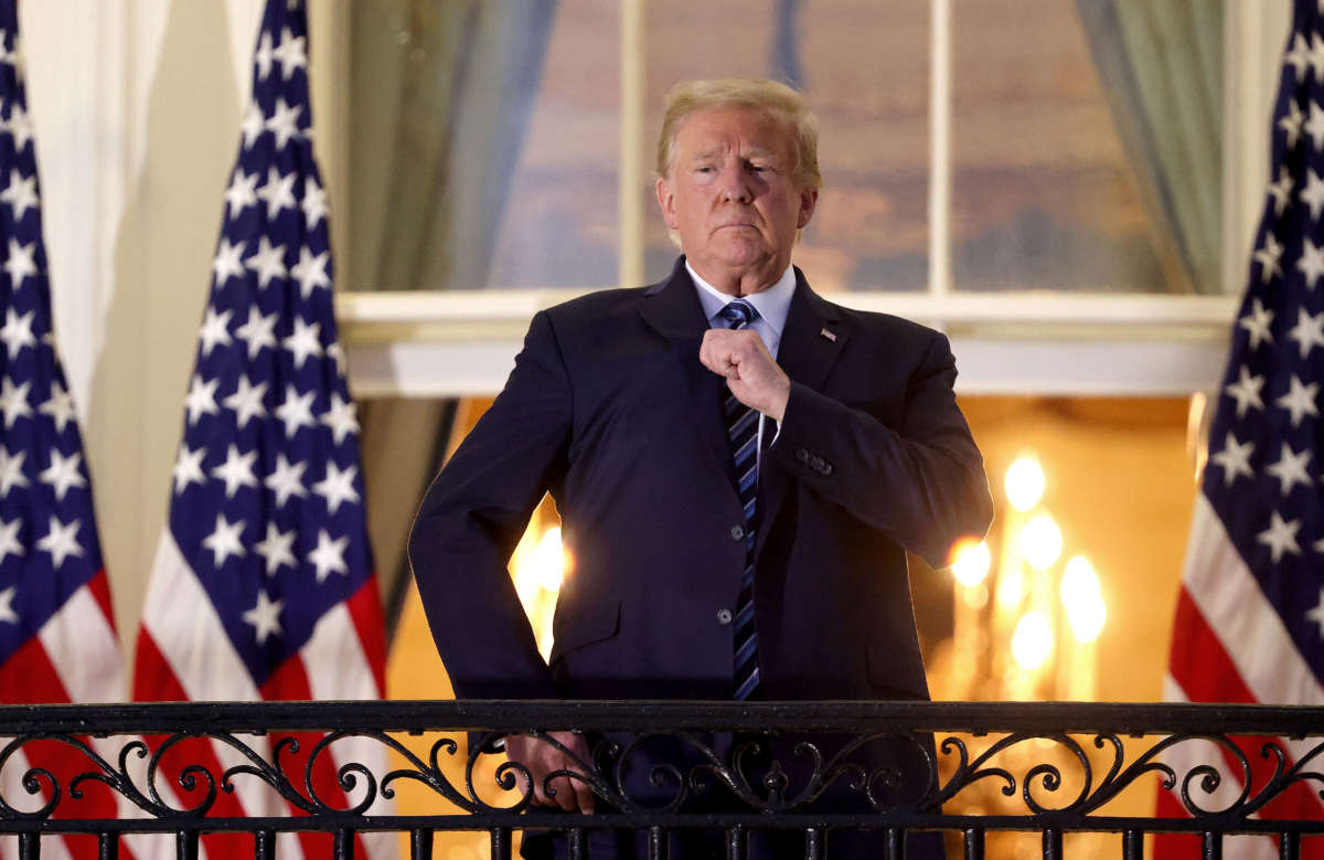 President Trump stands on the Truman Balcony after returning to the White House from Walter Reed National Military Medical Center on October 5, 2020, in Washington, D.C.