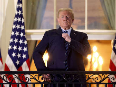 President Trump stands on the Truman Balcony after returning to the White House from Walter Reed National Military Medical Center on October 5, 2020, in Washington, D.C.