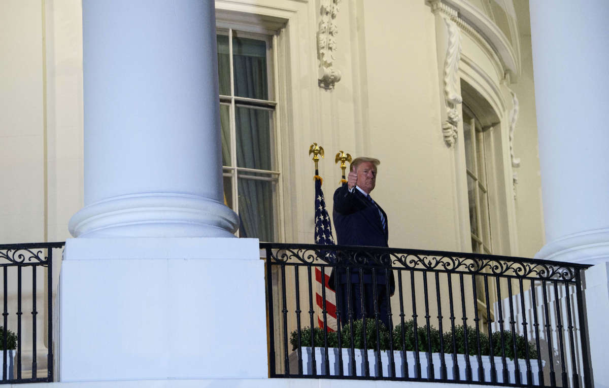 President Trump gives a thumbs up from the Truman Balcony upon his return to the White House from Walter Reed Medical Center, where he underwent treatment for COVID-19, in Washington, D.C, on October 5, 2020.