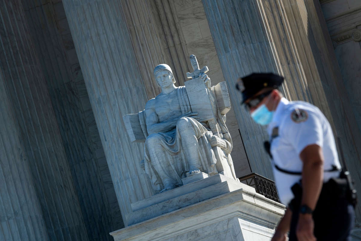 A guard is seen wearing a mask in front of the U.S. Supreme Court, on October 2, 2020, in Washington, D.C.