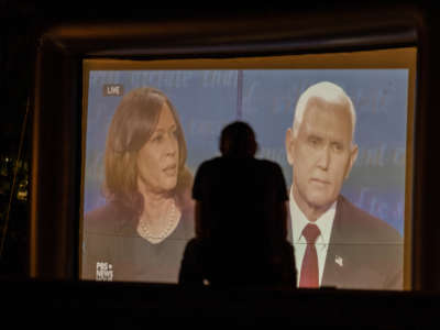 A student watches Democratic vice presidential candidate Kamala Harris and Republican Vice President Mike Pence speak on screen at the Conrad Prebys Amphitheater during the Vice Presidential Debate.