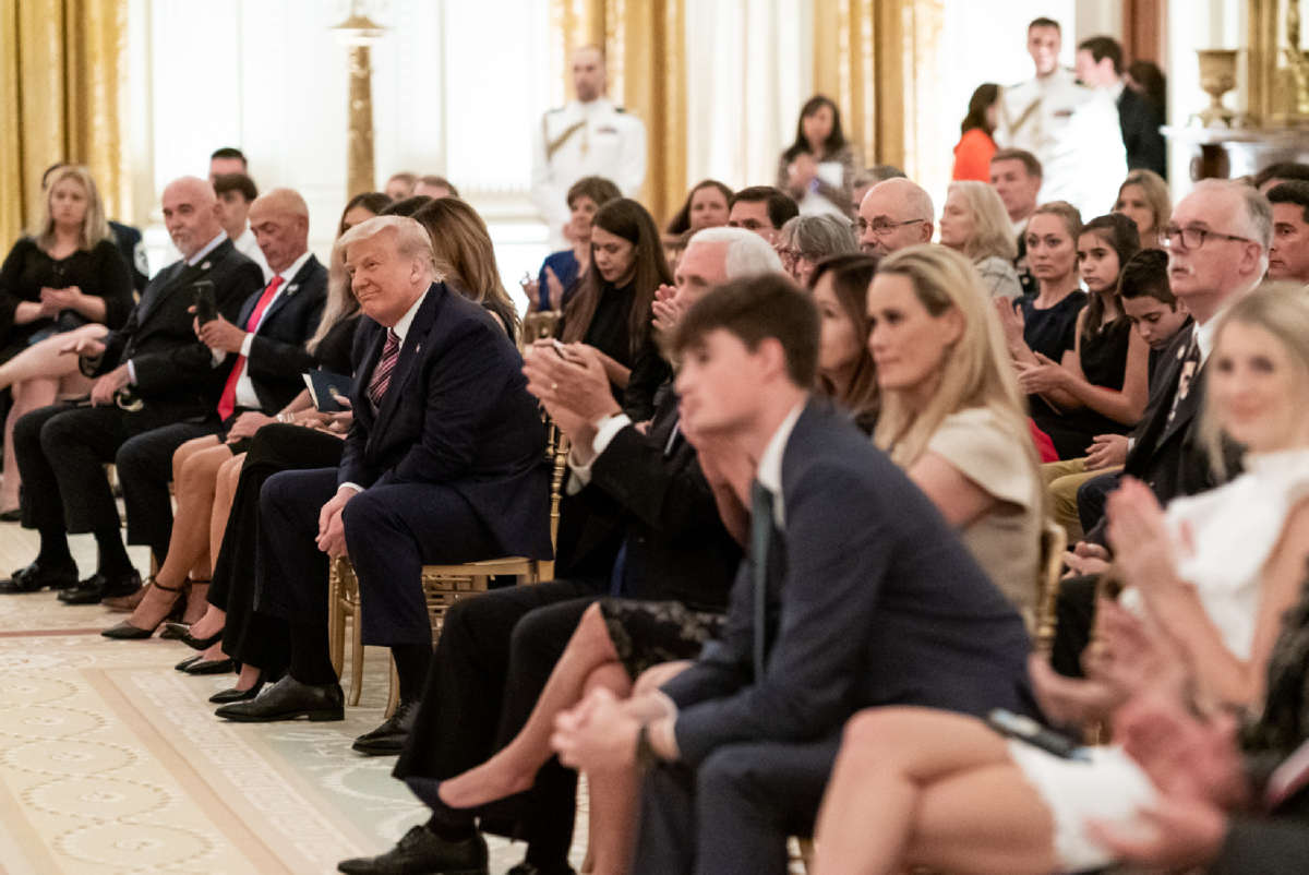 President Donald J. Trump listens as songs are sung at a remembrance candle lighting during a reception to honor Gold Star Families Sunday, September 27, 2020, in the East Room of the White House.