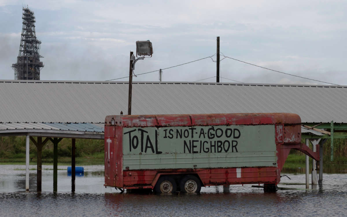 A protest sign is seen on a truck in flood water, from Hurricane Laura, by a Total oil refining plant near Port Arthur, Texas, on August 28, 2020.