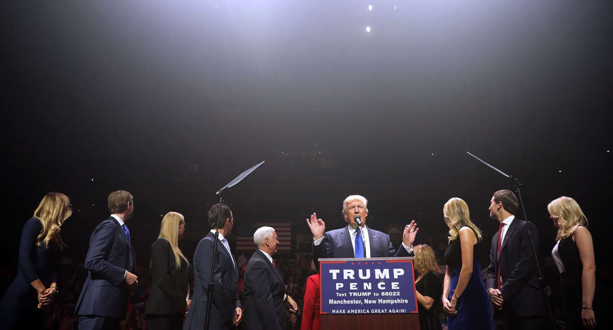 Then-presidential nominee Donald Trump is joined on stage by his family and Mike Pence during a campaign rally at the SNHU Arena November 7, 2016, in Manchester, New Hampshire.