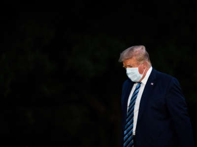 President Trump disembarks Marine One and walks across the South Lawn as he returns home after receiving treatments for the COVID-19 coronavirus at Walter Reed National Military Medical Center, at the White House on October 5, 2020, in Washington, D.C.