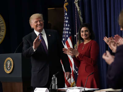 President Trump acknowledges the audience as Administrator of the Centers for Medicare and Medicaid Services Seema Verma looks on at the South Court Auditorium of the Eisenhower Executive Office Building, January 18, 2018, in Washington, D.C.