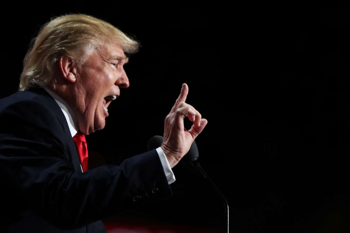 Then-Republican presidential candidate Donald Trump points to the crowd as he delivers a speech during the evening session on the fourth day of the Republican National Convention on July 21, 2016, at the Quicken Loans Arena in Cleveland, Ohio.