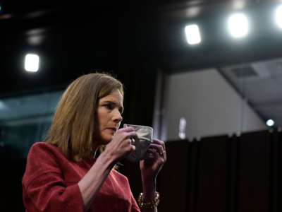 Supreme Court nominee Judge Amy Coney Barrett puts on her mask at start of recess break in the second day of her Senate Judiciary committee confirmation hearing on Capitol Hill on October 13, 2020, in Washington, D.C.