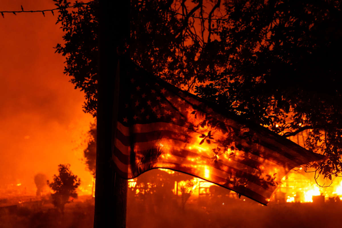 A U.S. flag flaps in the wind as the Shady Fire impacts structures in Santa Rosa, California, on September 28, 2020.