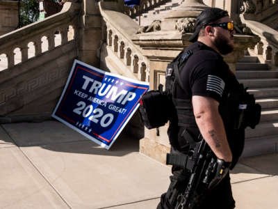 A Second Amendment protester listens to gun-rights advocates speak during a rally on the Michigan Capitol Building lawn on September 17, 2020, in Lansing, Michigan.