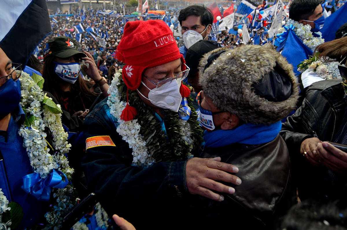 Luis Arce, presidential candidate of the MAS party, greets a supporter after a final rally in El Alto, Bolivia, October 14, 2020.