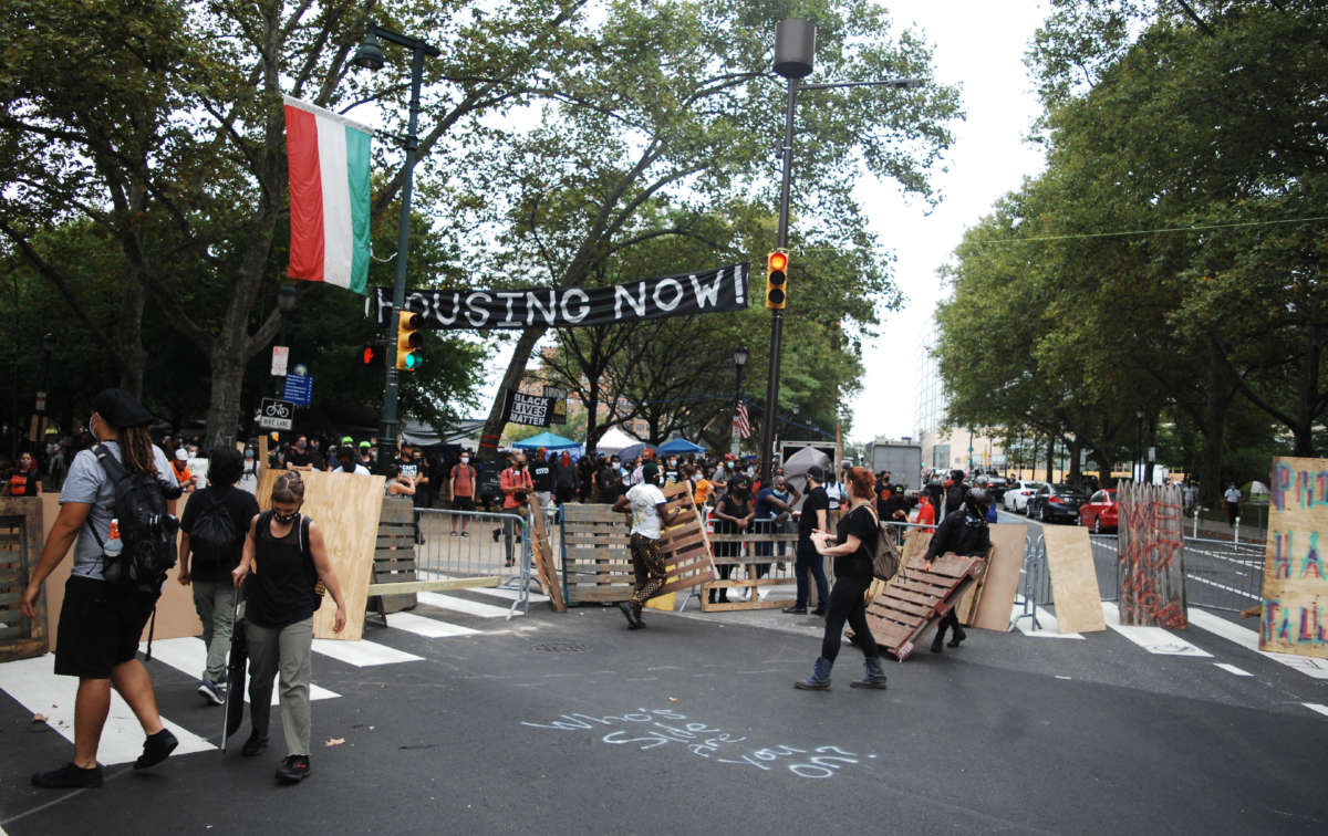 Camp James Talib-Dean residents and housing activists erect barricades at the main entrance to the encampment on the Benjamin Franklin Parkway in Philadelphia on September 9, 2020.