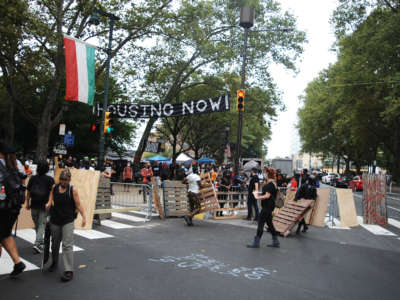 Camp James Talib-Dean residents and housing activists erect barricades at the main entrance to the encampment on the Benjamin Franklin Parkway in Philadelphia on September 9, 2020.