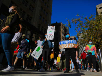 Protestors gather at Boston City hall and march through the Boston downtown as they march to demand immediate action for climate justice at Boston, Massachusetts, October 15, 2020.