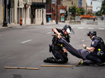 Two cops violently arrest someone in the middle of a deserted street